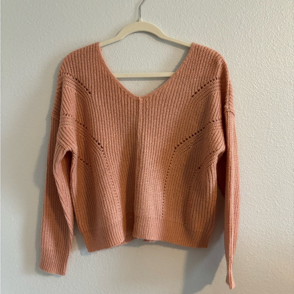 Peach colored cropped sweater. Buttons down the back. Never worn